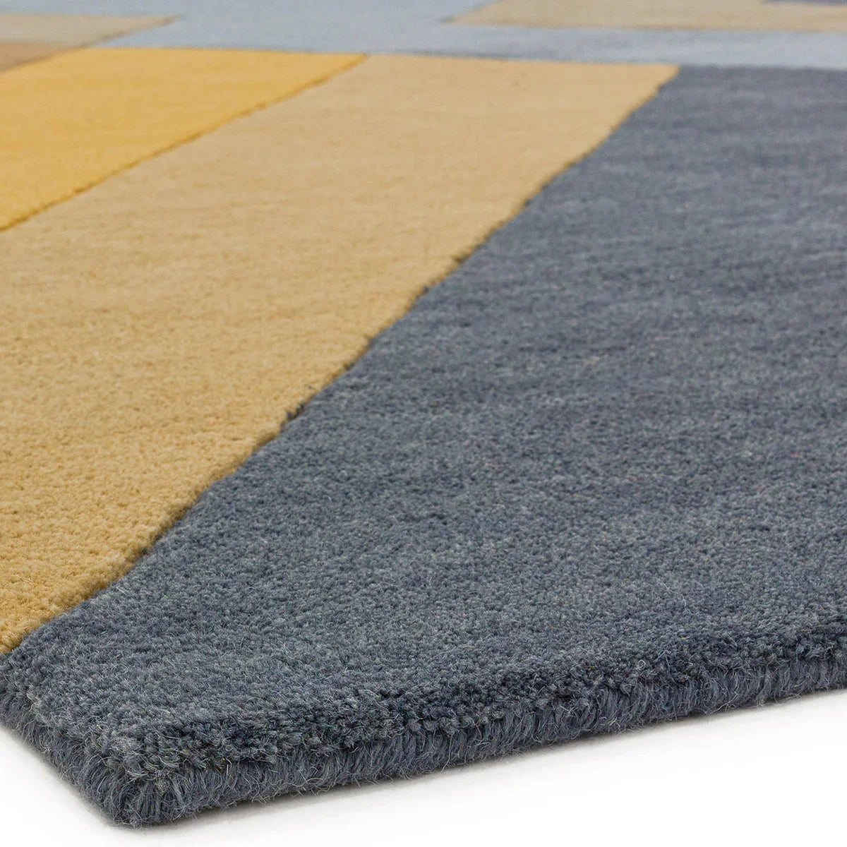 Asiatic Reef Big Zig Ochre Grey Rug featuring zig pattern in ochre, navy blue and slate grey on blue-grey background, hand-tufted wool