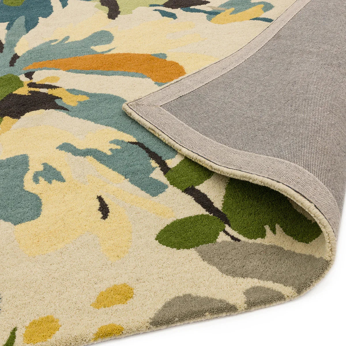 Asiatic Reef Floral Green Multi Designer Rug featuring a vibrant botanical floral pattern in emerald green, teal, mustard yellow and navy on a cream background, hand-tufted wool