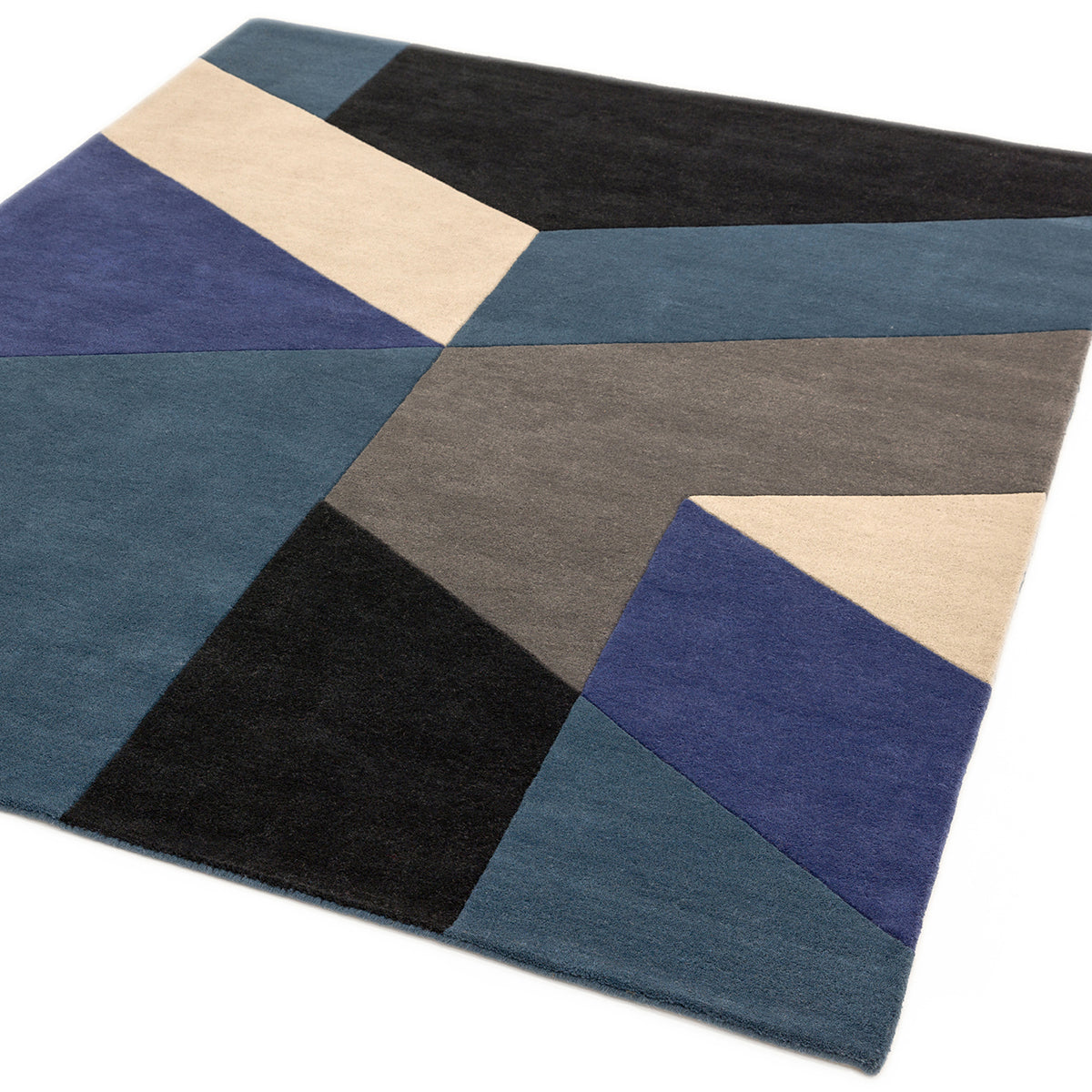 Geometric patterned rug with blue, black, and beige colors on a white background