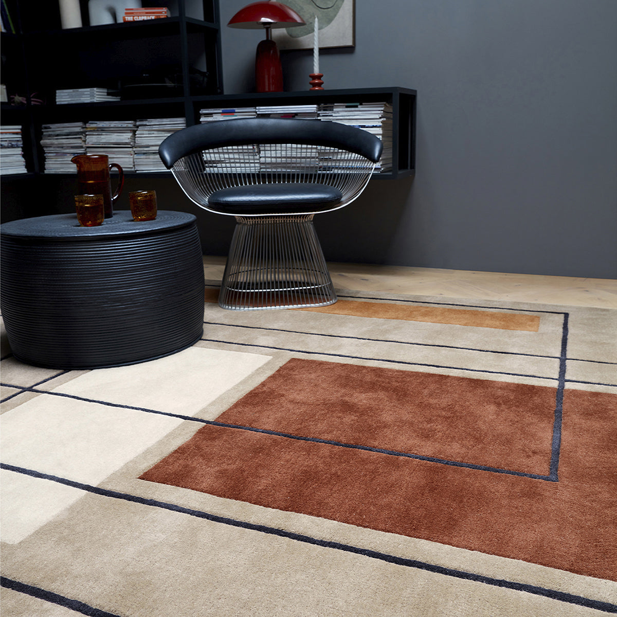Modern living room with a rug, chair, and coffee table.
