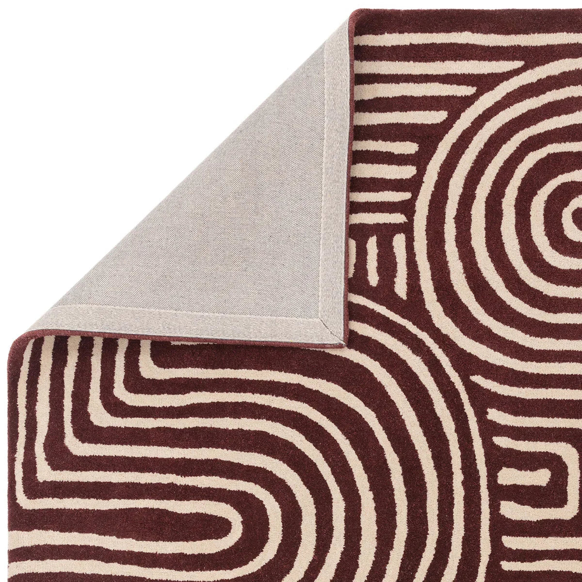 Asiatic Reef Curve Plum Rug featuring spiral curved pattern in plum and ivory on cream background, hand-tufted wool