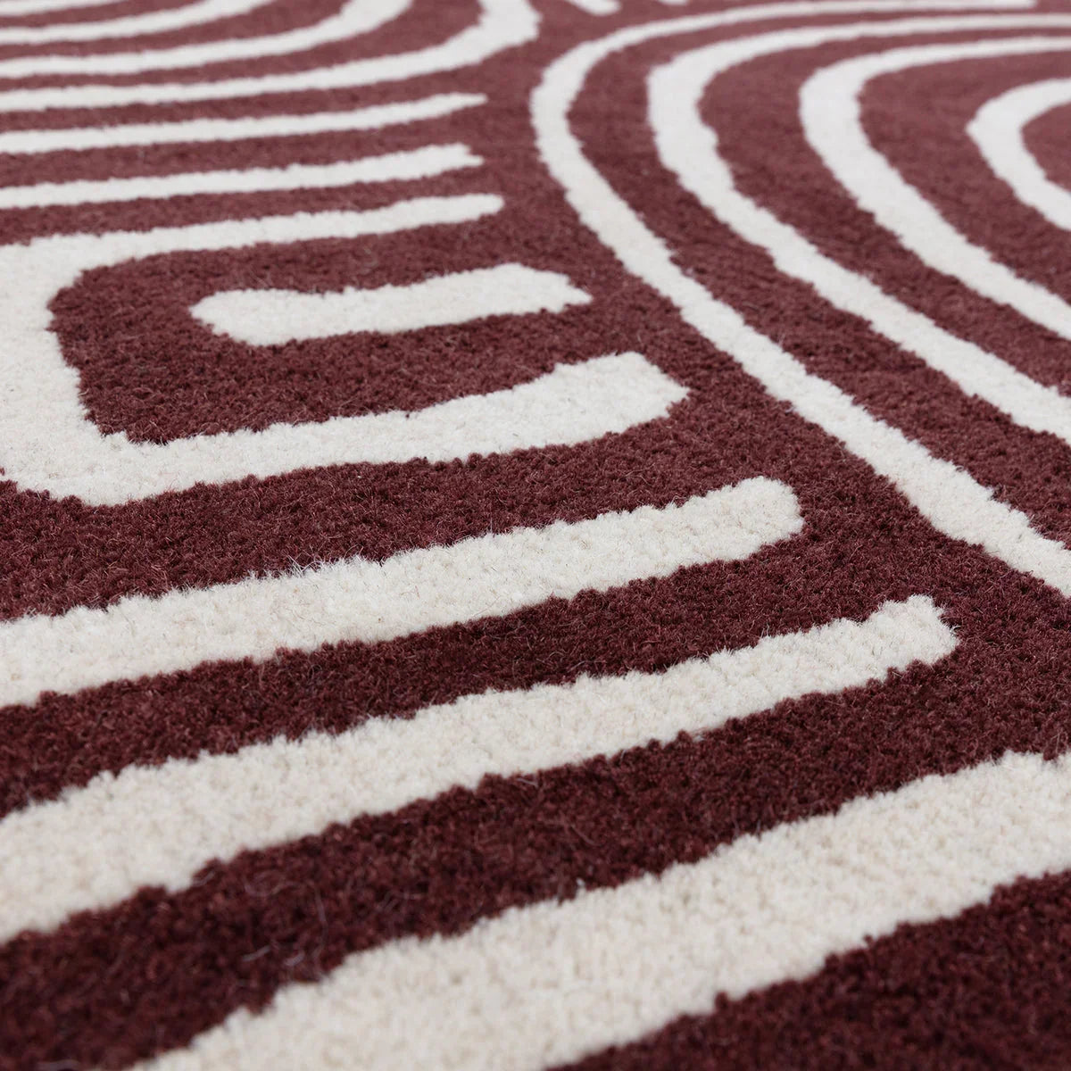 Asiatic Reef Curve Plum Designer Rug featuring reef/curve pattern in plum and cream on ivory background, hand-tufted wool