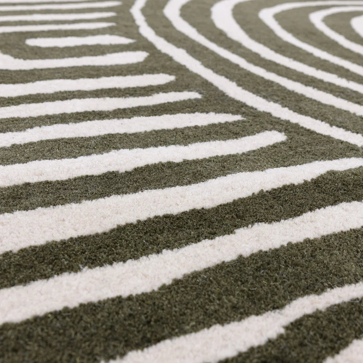 Asiatic Reef Curve Forest Rug featuring curved stripe pattern in forest green and cream on olive, hand-tufted wool