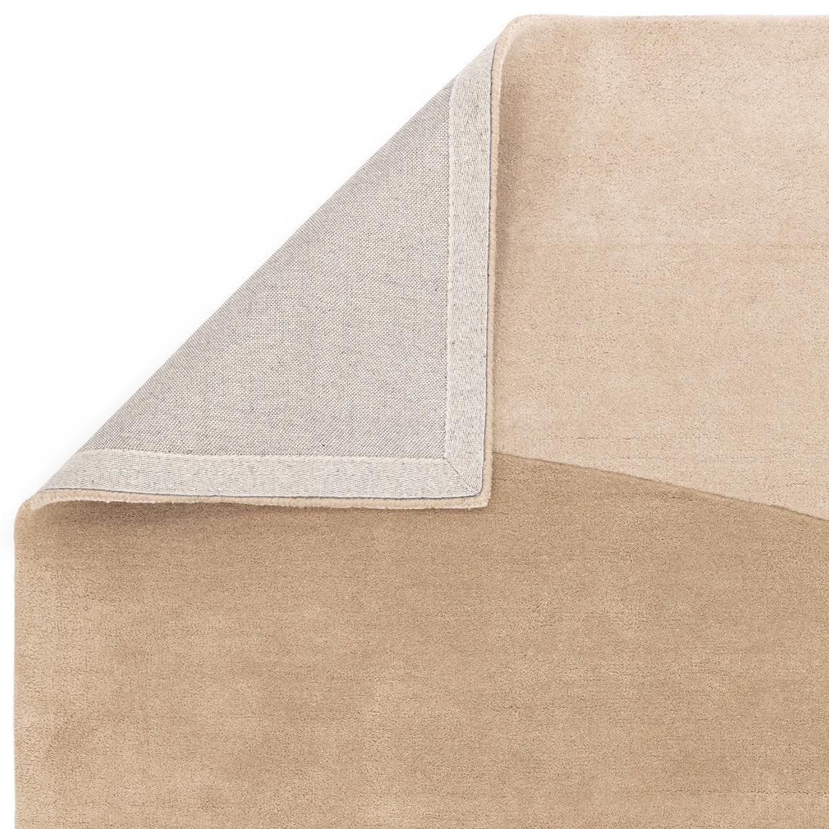 Asiatic Reef Horizon Designer Rug featuring solid beige field with light grey edge border on tan background, machine-made rug