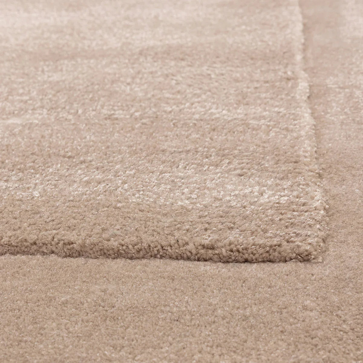 Asiatic Rise Sand Designer Rug featuring geometric block pattern in sand and beige on warm beige background, tufted construction