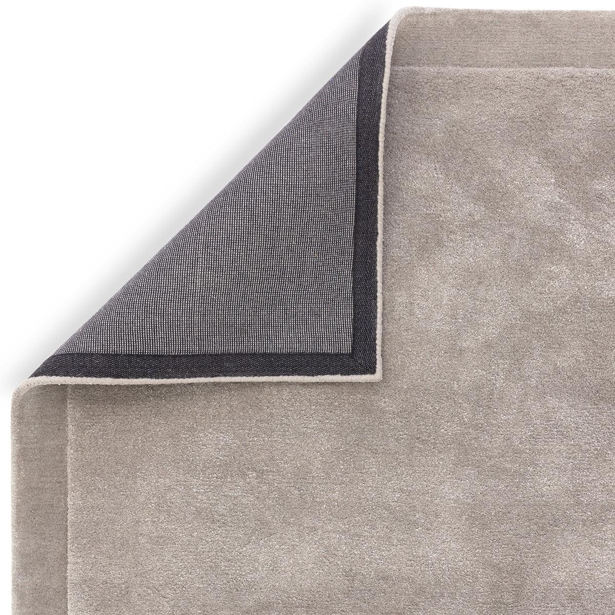 Asiatic Rise Silver Designer Rug featuring solid minimalist texture in silver-beige with navy border on light taupe, machine-woven wool