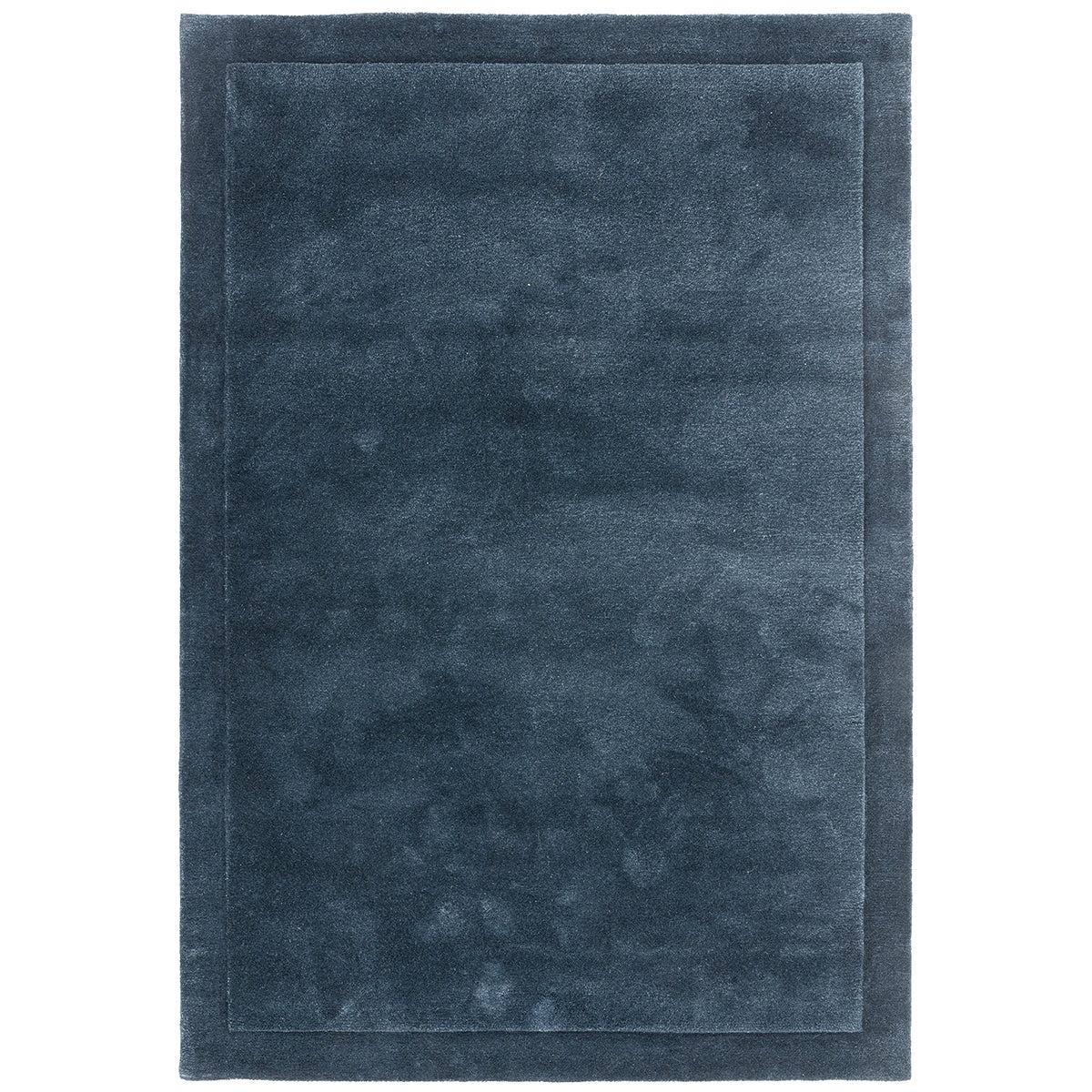 Solid dark blue rug on a white background