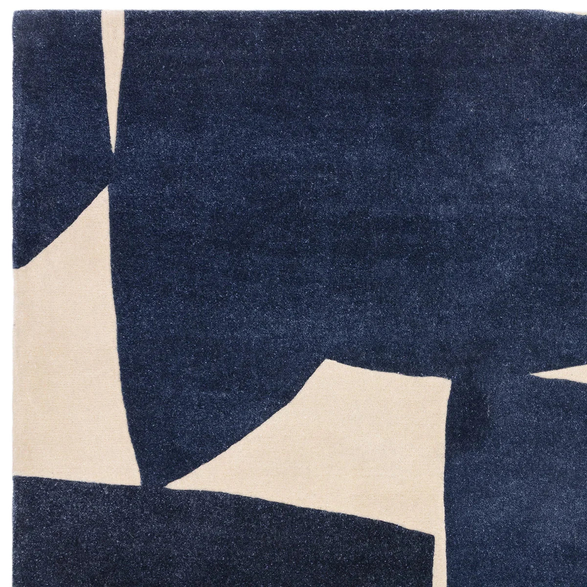 Asiatic Romy Kite Blue Designer Rug featuring abstract geometric pattern in navy blue and beige on navy background, hand-tufted wool