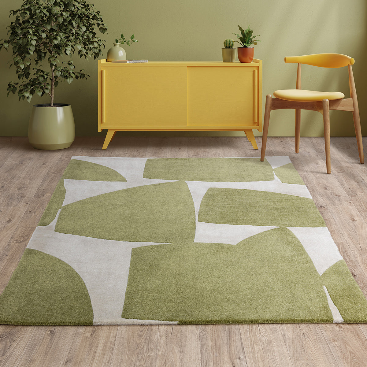 Room interior with a green and beige abstract rug, yellow cabinet, and wooden chair.