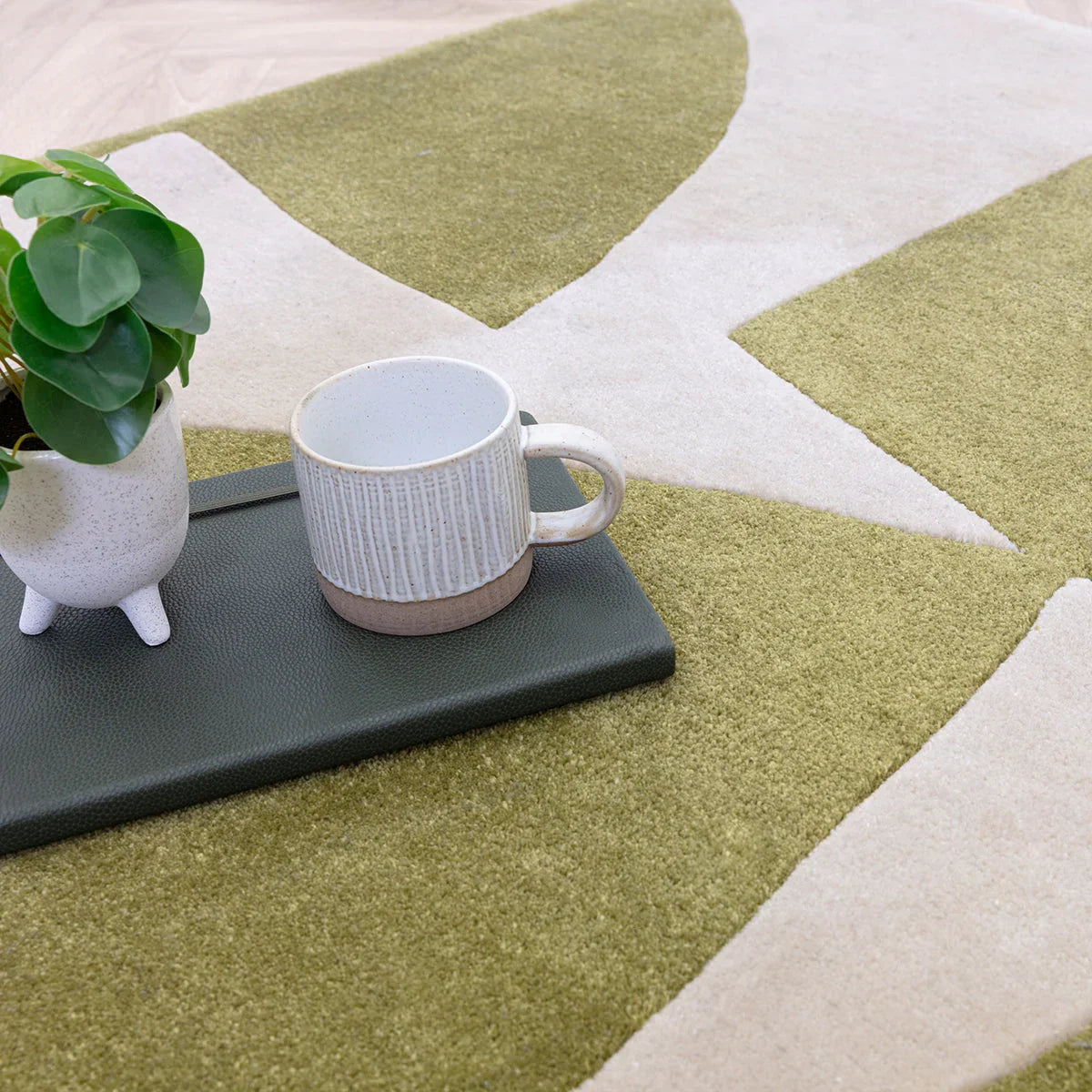 Asiatic Romy Kite Sage rug featuring geometric kite pattern in sage, olive and cream on light cream background, hand-tufted wool