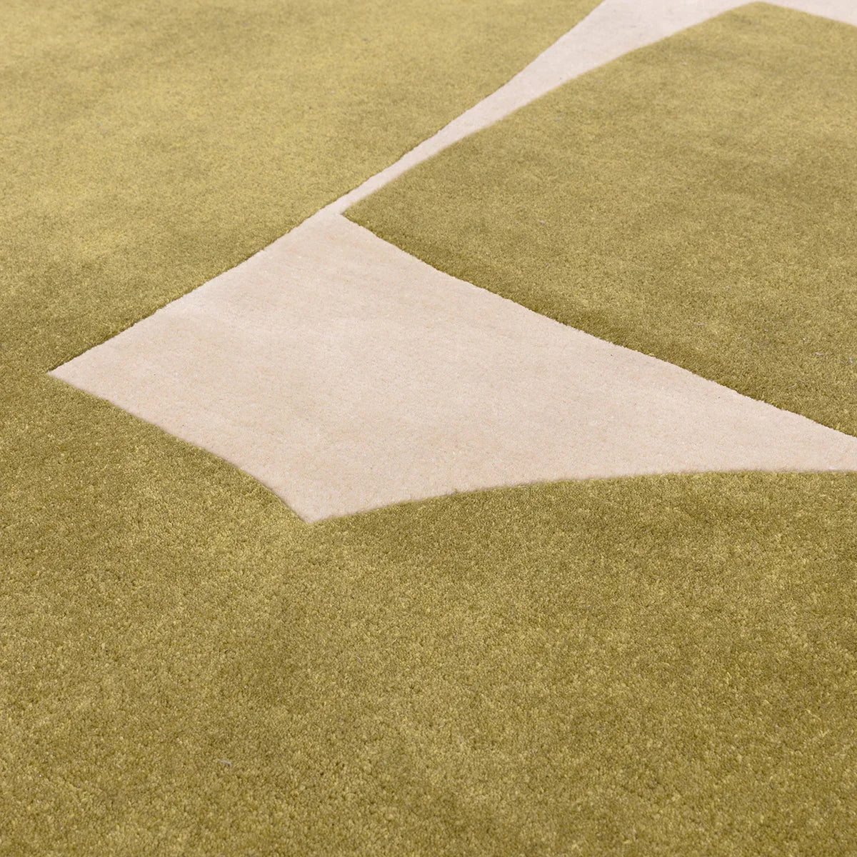 Asiatic Romy Kite Sage Rug featuring geometric kite pattern in sage, beige and olive on sage background, hand-tufted wool