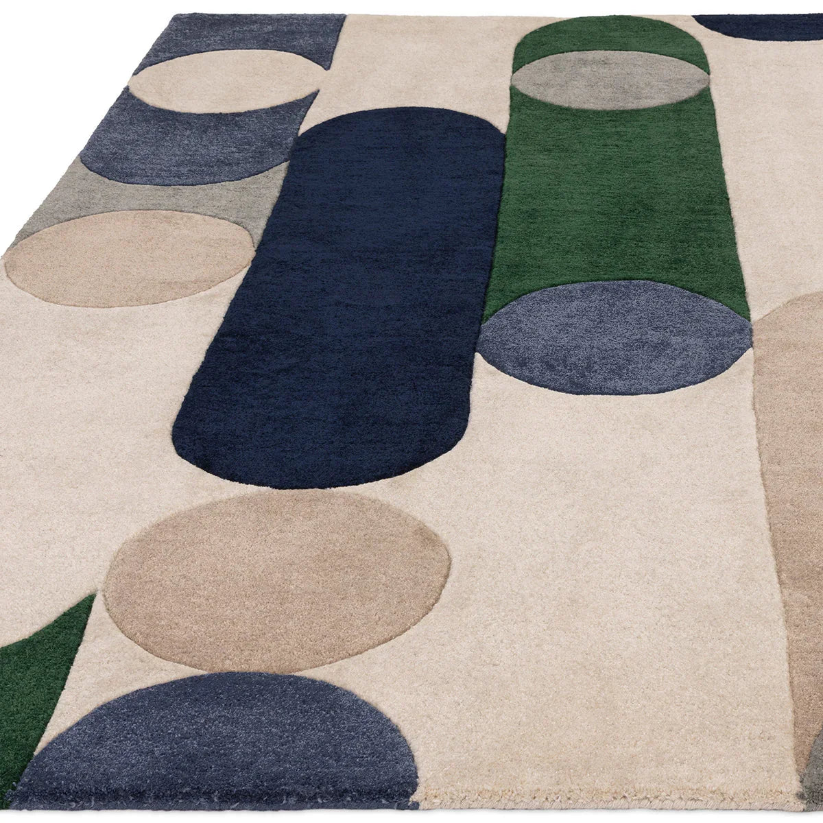 Asiatic Romy Morse Blue rug featuring geometric circular pattern in navy, dark blue, sage green, taupe and cream on beige, machine-made wool