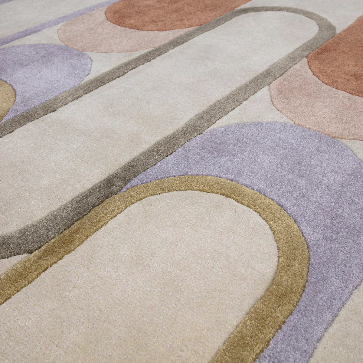 Asiatic Romy Module Pastel Designer Rug featuring abstract circular pattern in lavender, lilac, blush pink, sand beige and ochre on cream background, hand-tufted wool