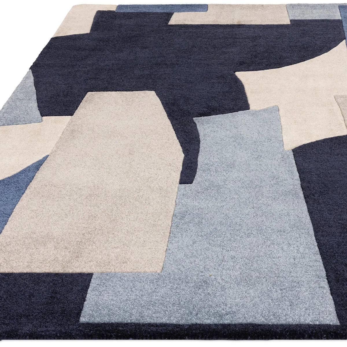 Asiatic Romy Element Blue rug featuring geometric patchwork in navy, beige and light blue on pale blue background, hand-tufted wool