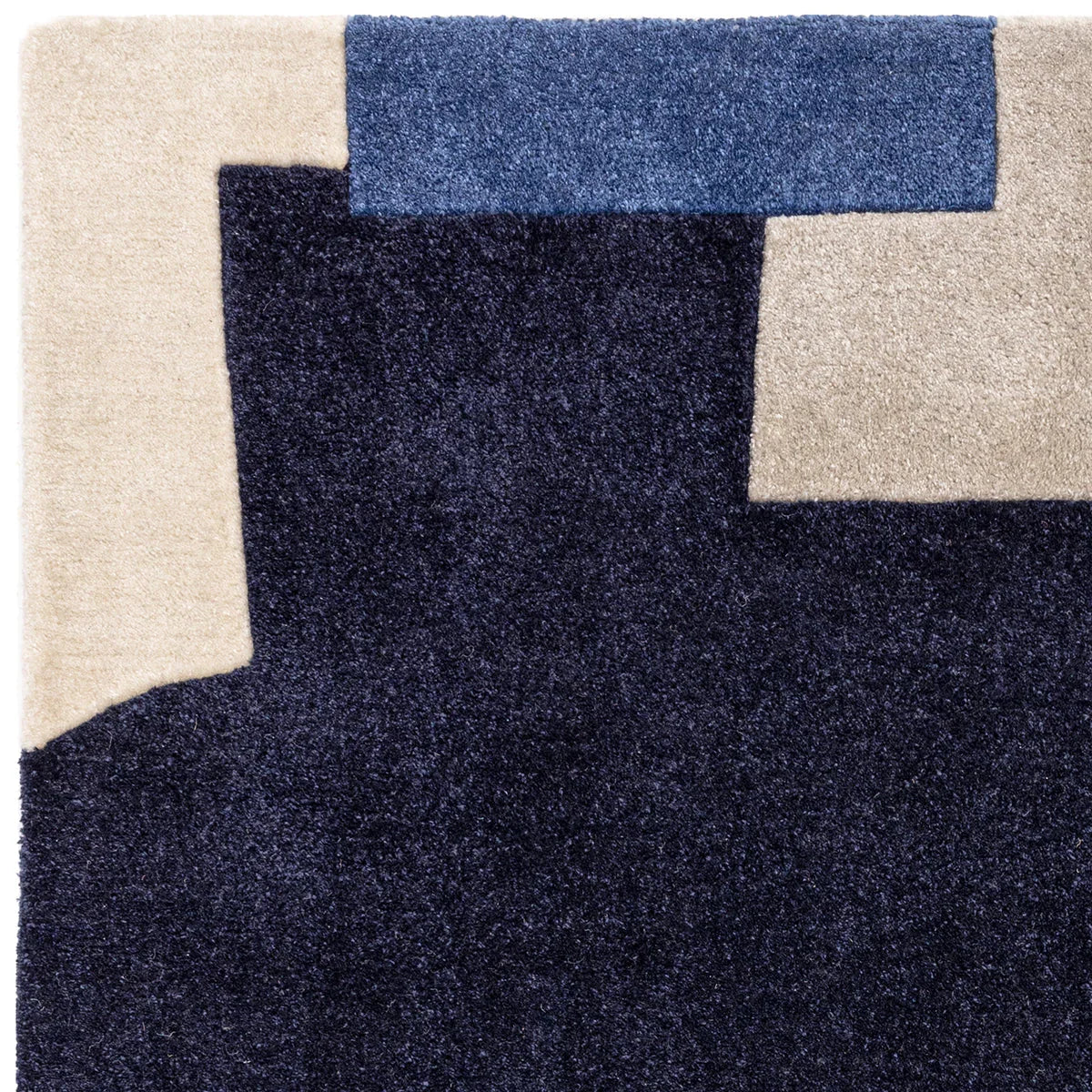 Asiatic Romy Element Blue rug with geometric blocks in navy, deep blue, blue-gray and beige on cream background, hand-tufted wool