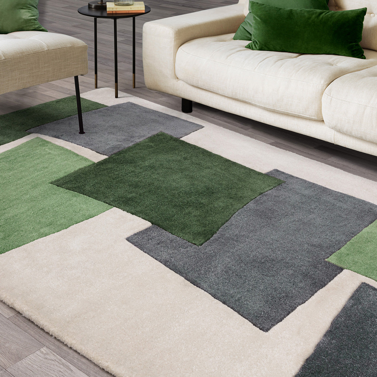 Living room with a geometric patterned rug featuring green, gray, and beige colors.