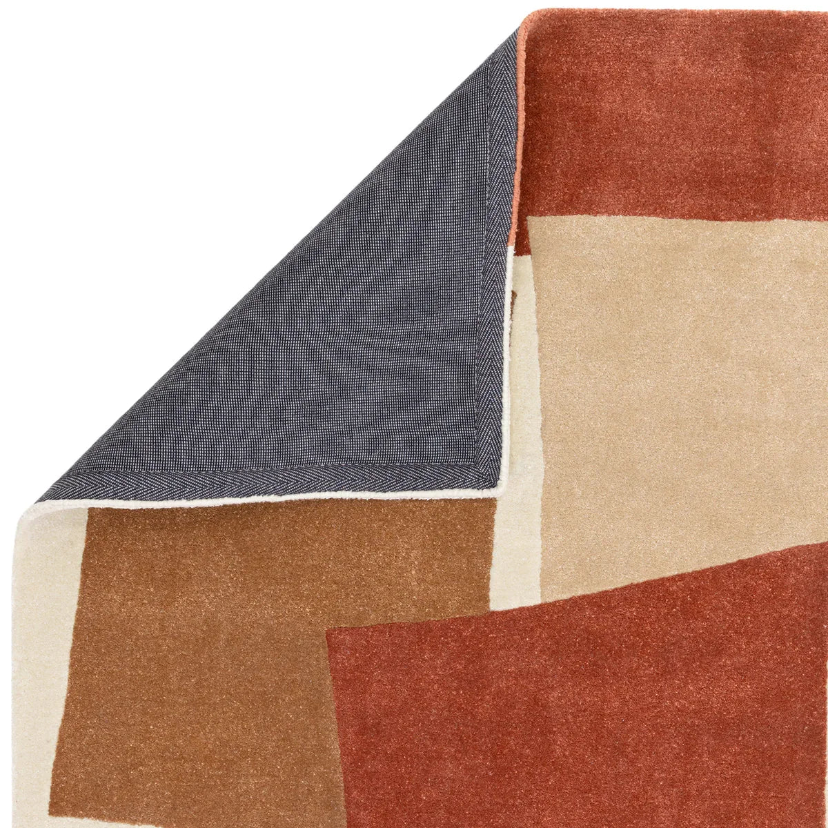 Asiatic Romy Papercut Red rug featuring geometric patchwork in crimson, rust, beige and cream on navy backing, hand-tufted wool