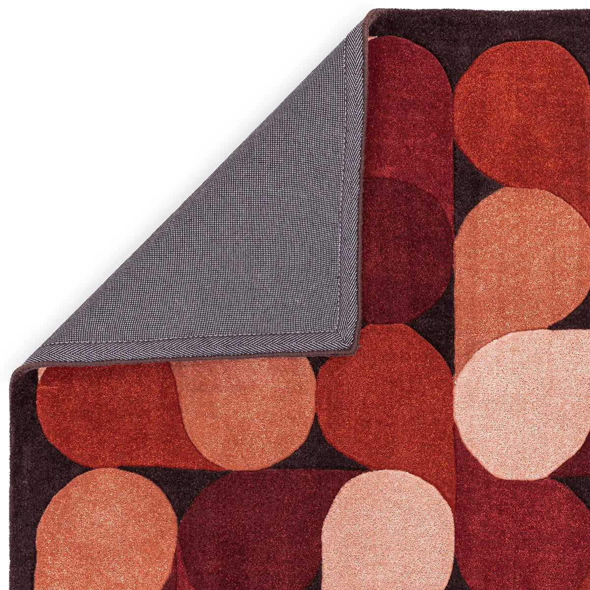 Asiatic Romy Jive Red Designer Rug featuring circular geometric pattern in rich red, burgundy, rose and blush on dark charcoal, hand-tufted wool