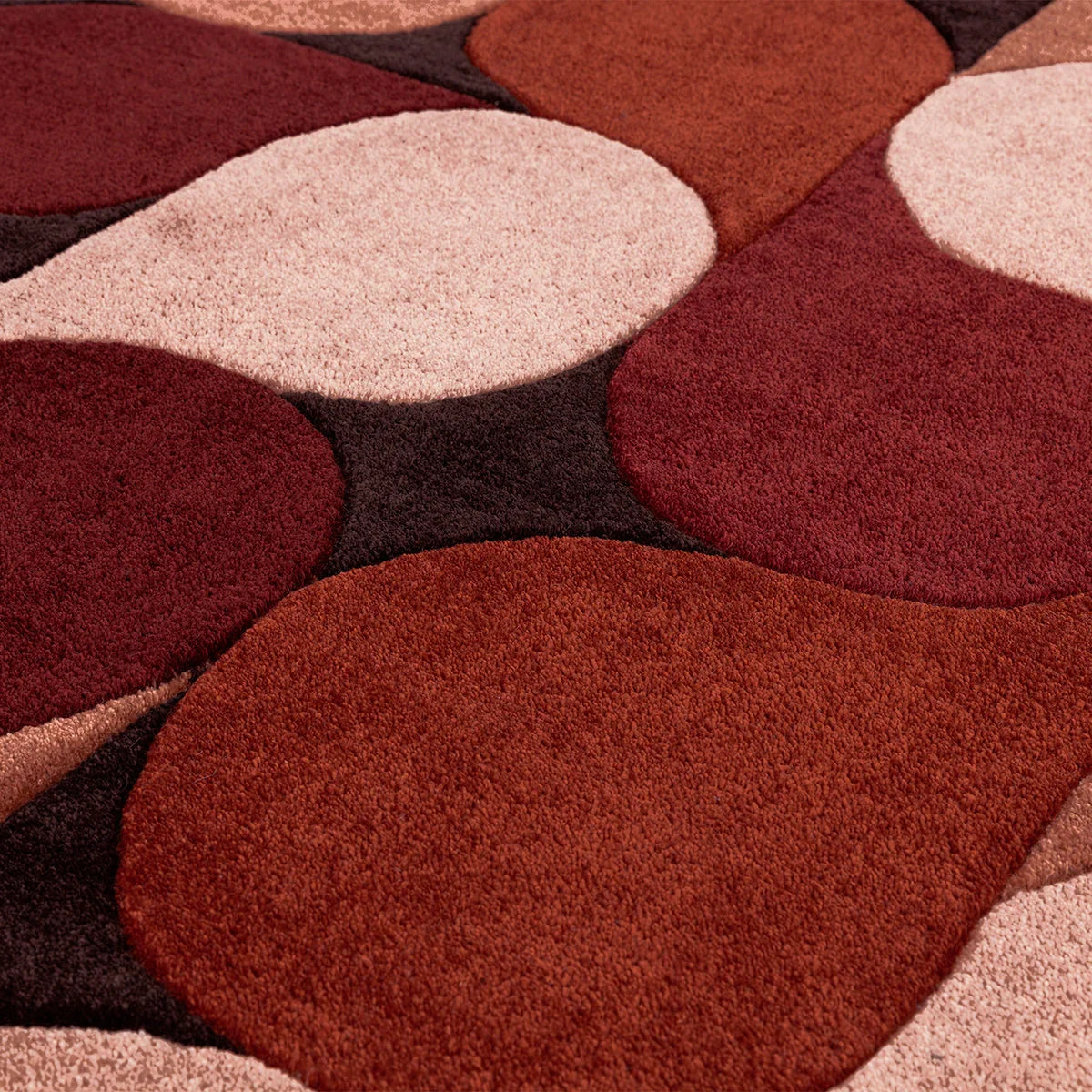 Asiatic Romy Jive Red Rug featuring abstract circles in deep red, burgundy and pink on dark background, hand-tufted wool