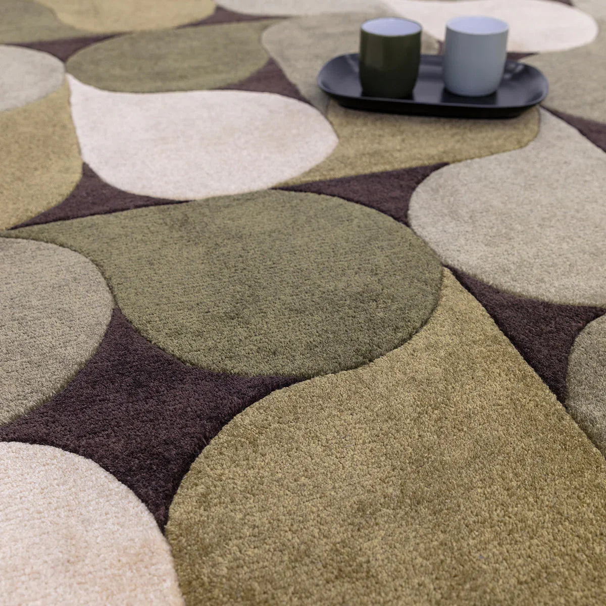 Asiatic Romy 15 Jive Green rug featuring abstract circular pattern in olive green, sage, cream and taupe on beige background, hand-tufted wool