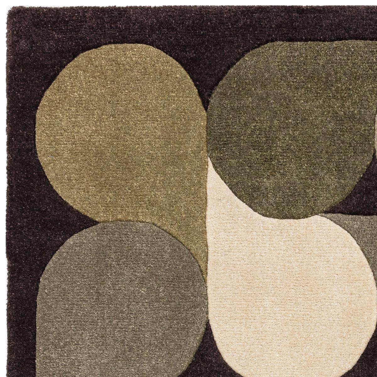 Asiatic Romy Jive Green rug featuring abstract circular pattern in olive, sage, charcoal and beige on dark brown background, hand-tufted wool