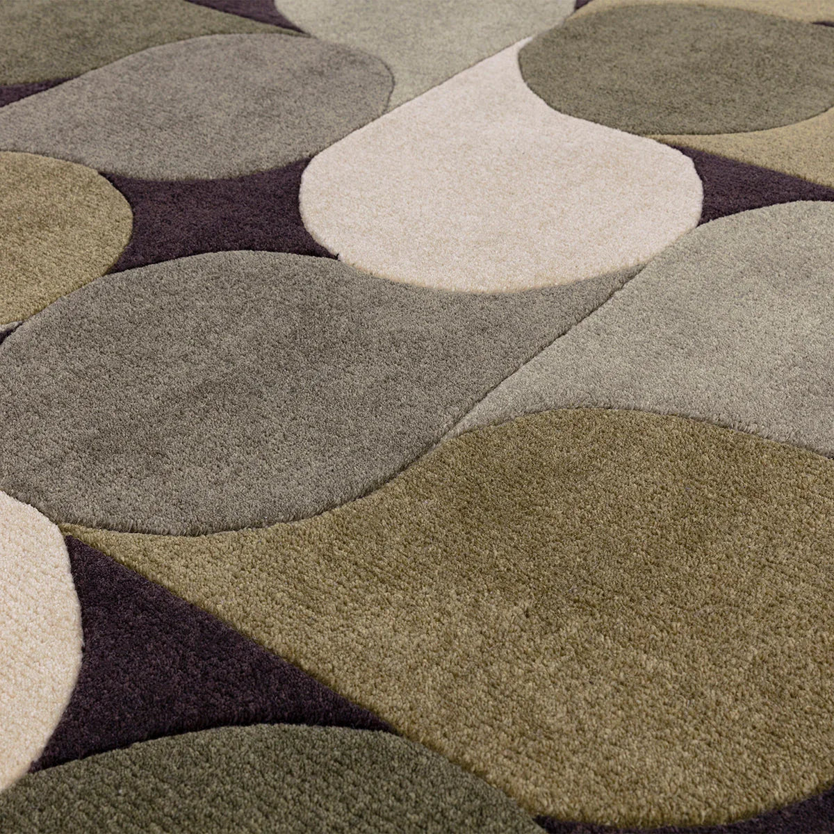 Asiatic Romy Jive Green rug featuring circular abstract pattern in olive, sage, cream, taupe and plum on dark background, hand-tufted wool