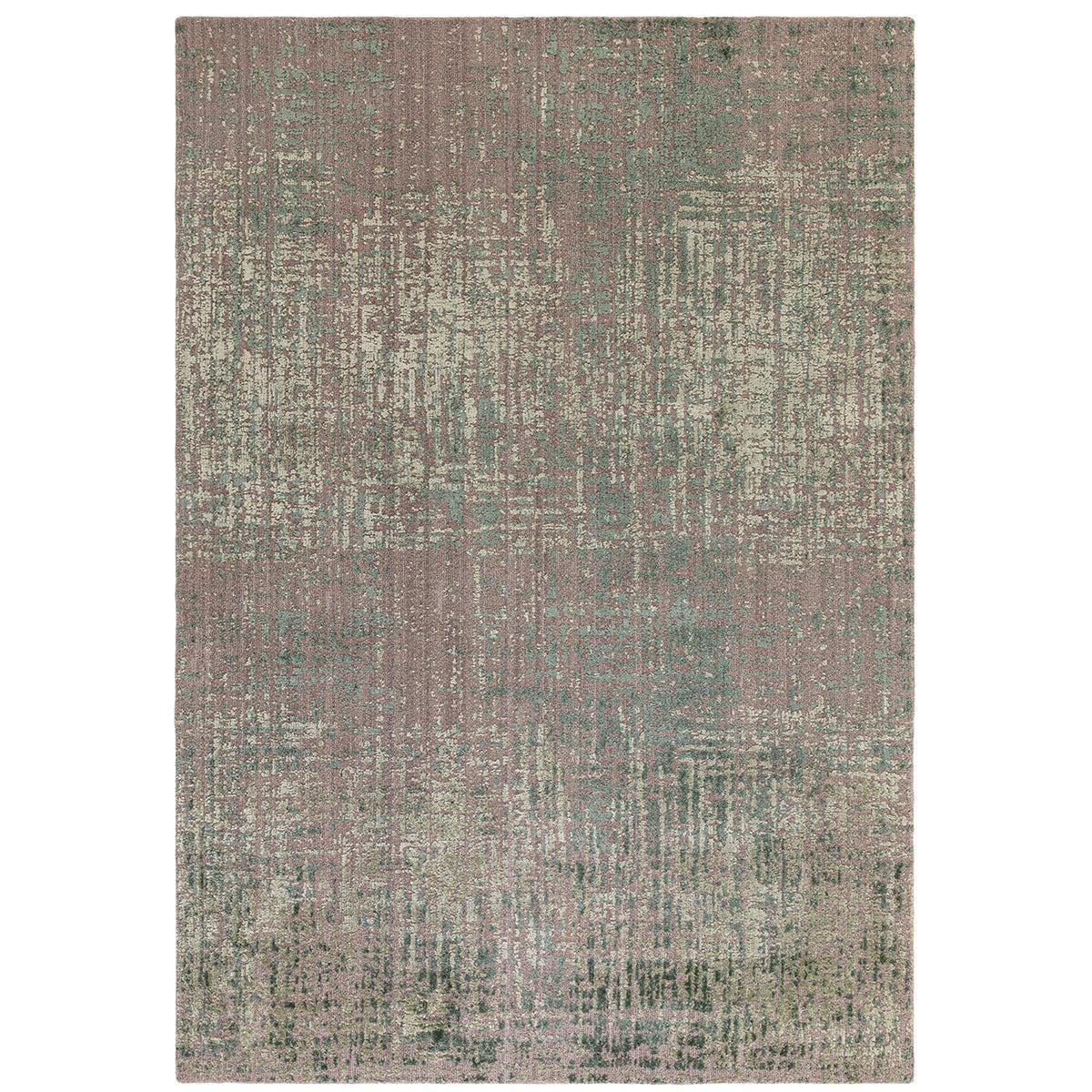 Textured area rug with a pattern of brown, green, and beige colors on a plain background