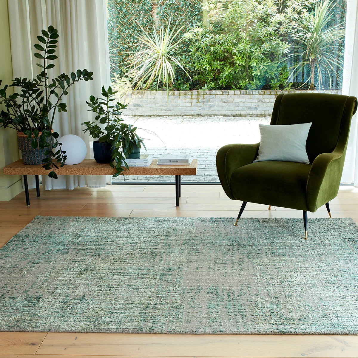 Asiatic Torino Forest Green Designer Rug featuring abstract distressed pattern in forest green, teal, sage and ivory on light beige background, hand-tufted wool