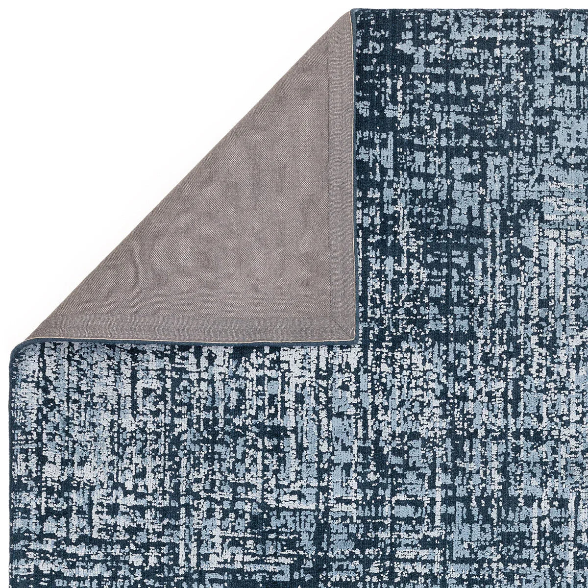 Asiatic Torino Petrol Blue Rug featuring abstract distressed pattern in petrol blue, navy and light blue on charcoal background, hand-tufted wool
