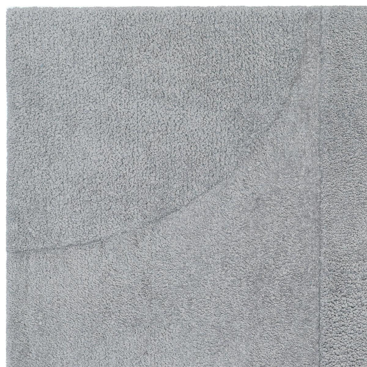 Asiatic Tova Blue Designer Rug featuring plush textured pile in blue-grey on soft grey background, hand-tufted wool