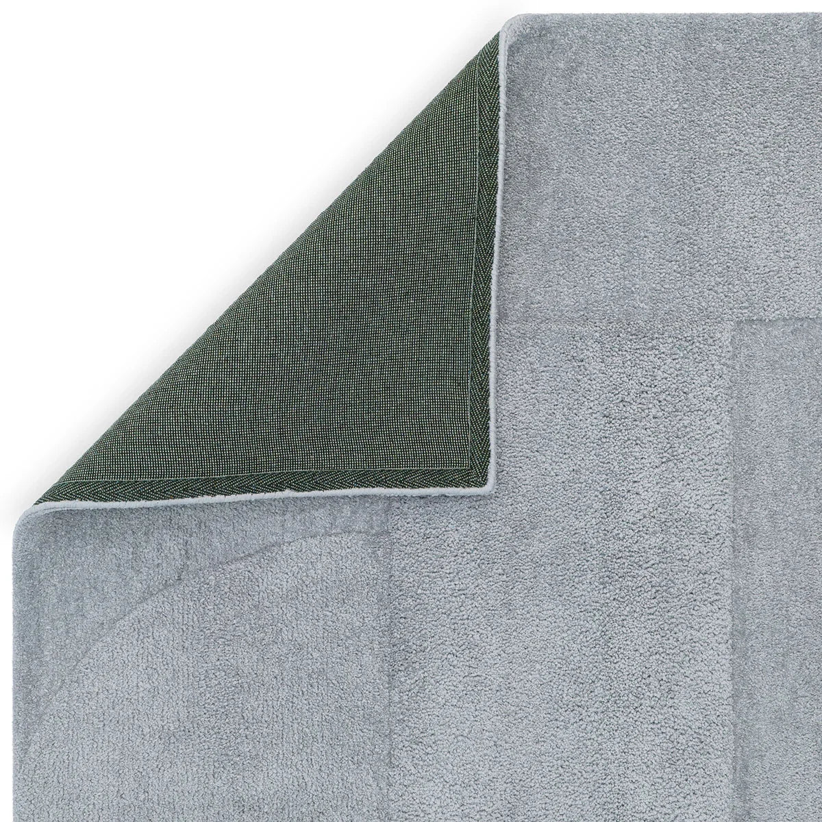Asiatic Tova Blue Designer Rug featuring light blue textured pile with dark green underside on pale blue background, hand-tufted wool