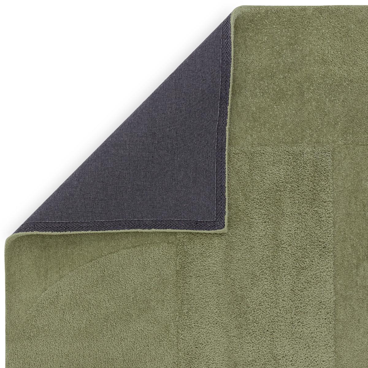 Asiatic Tova Green Designer Rug featuring solid olive-green plush top with navy underside on white background, hand-tufted wool