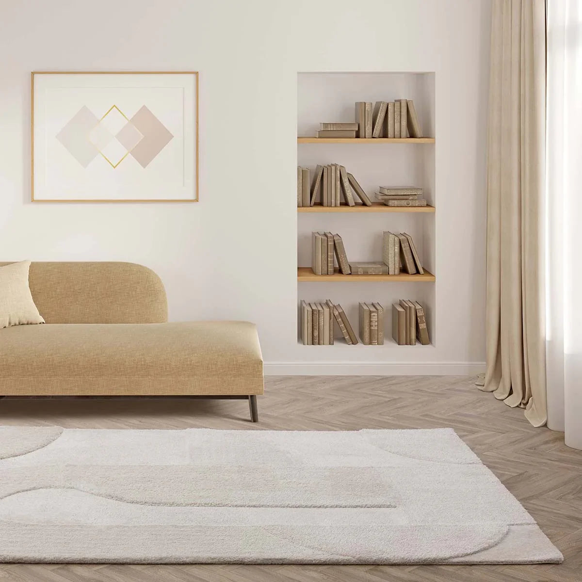 Modern living room with beige sofa, bookshelf, and abstract art on a white wall.