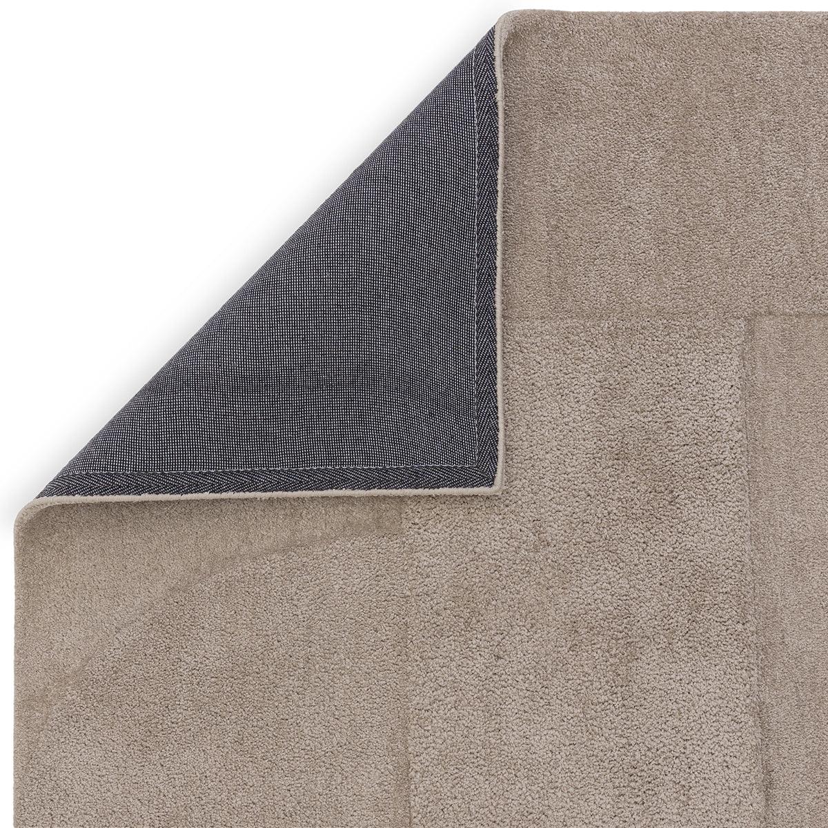 Asiatic Tova Moleskin Designer Rug featuring solid textured design in taupe, beige and navy on white background, hand-tufted wool