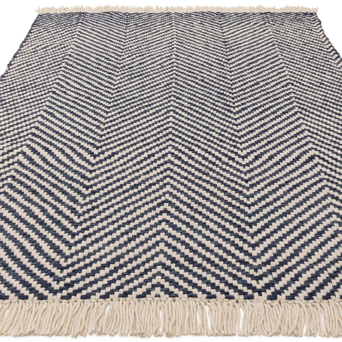 Asiatic Vigo Navy Designer Rug featuring chevron pattern in navy blue and cream on ivory background, woven cotton