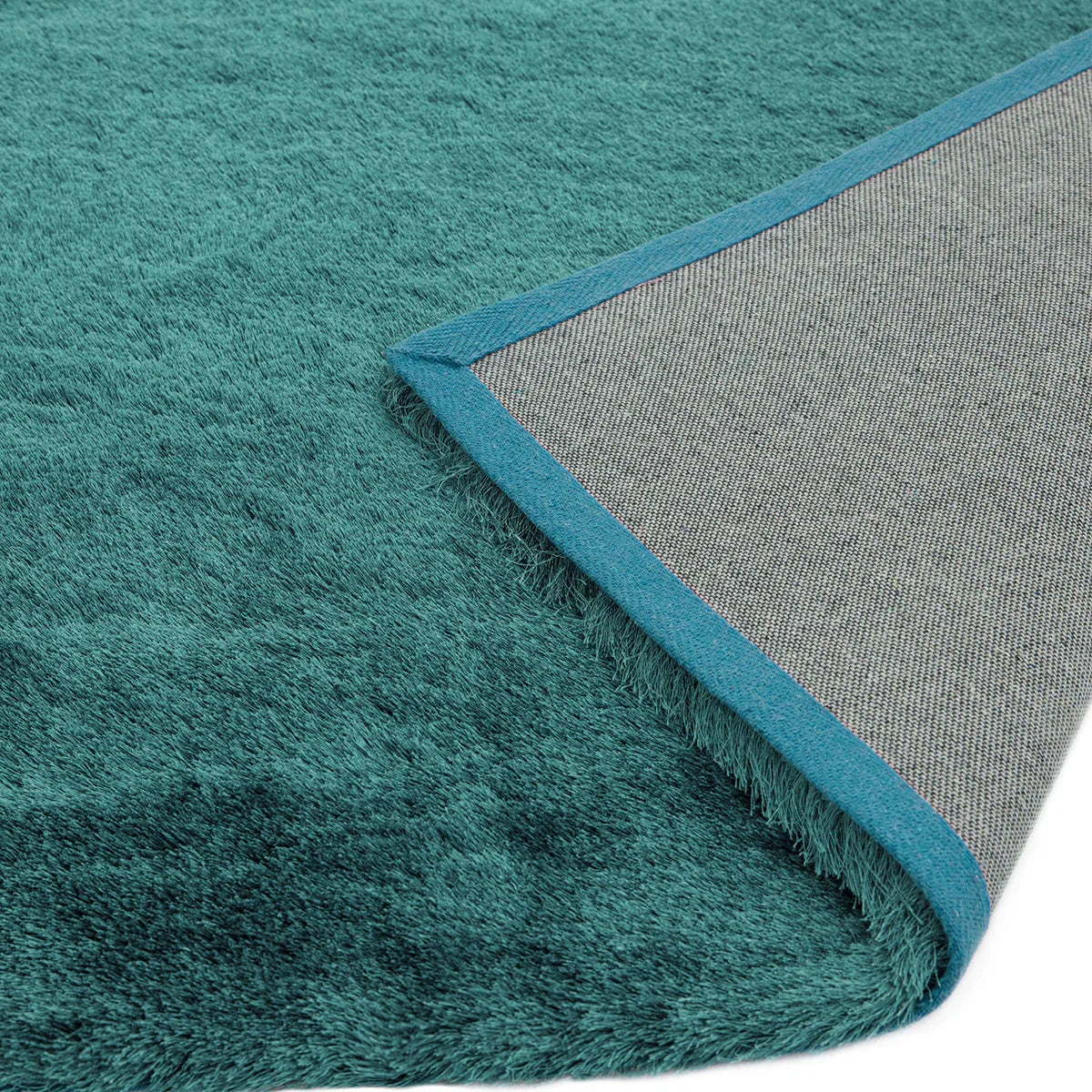 Asiatic Whisper Dark Teal Designer Rug featuring solid shag pile in dark teal and teal border on grey backing, machine-made polyester
