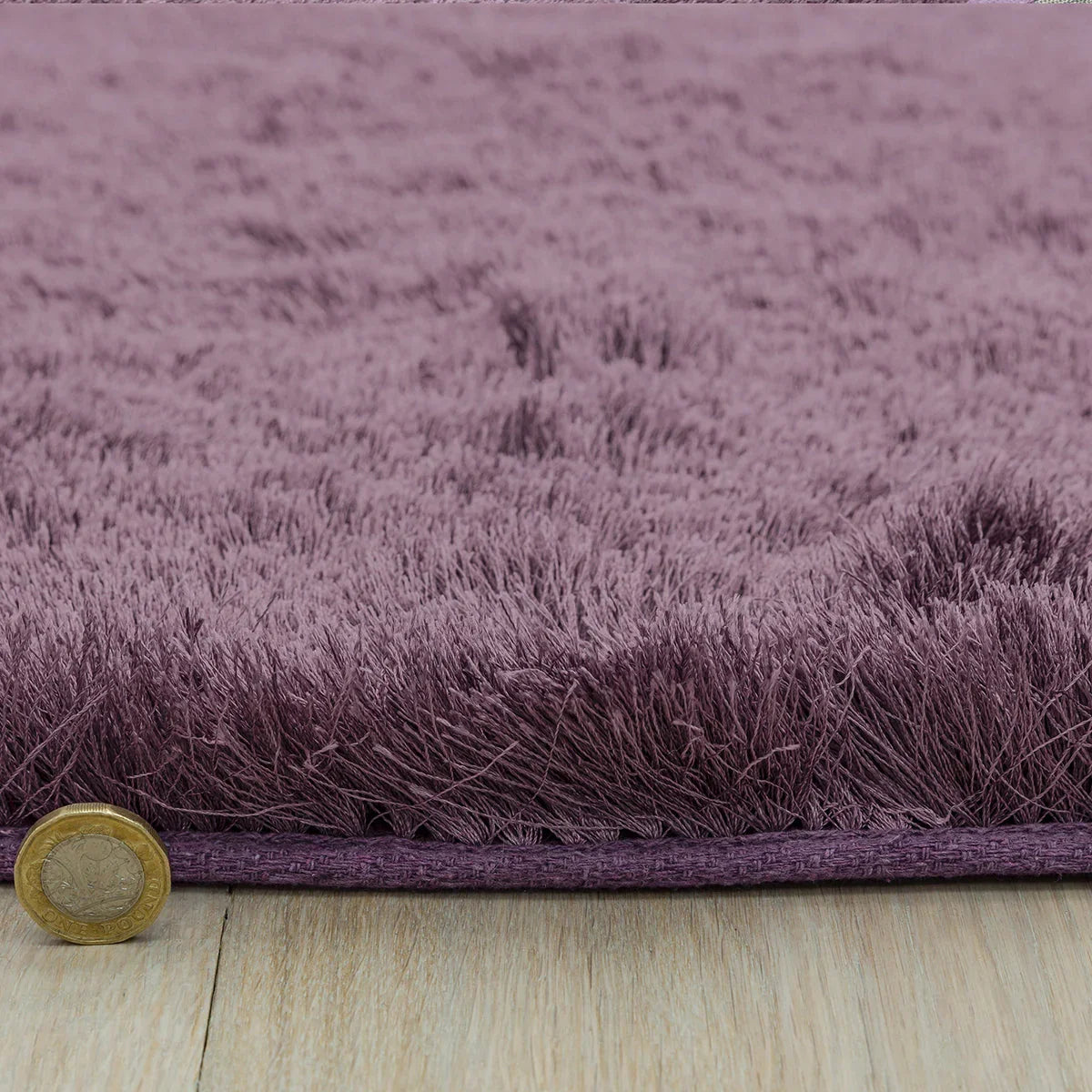 Asiatic Whisper Heather Rug featuring shaggy solid colour in dusty purple, lavender and plum on light wooden floor, hand-tufted wool