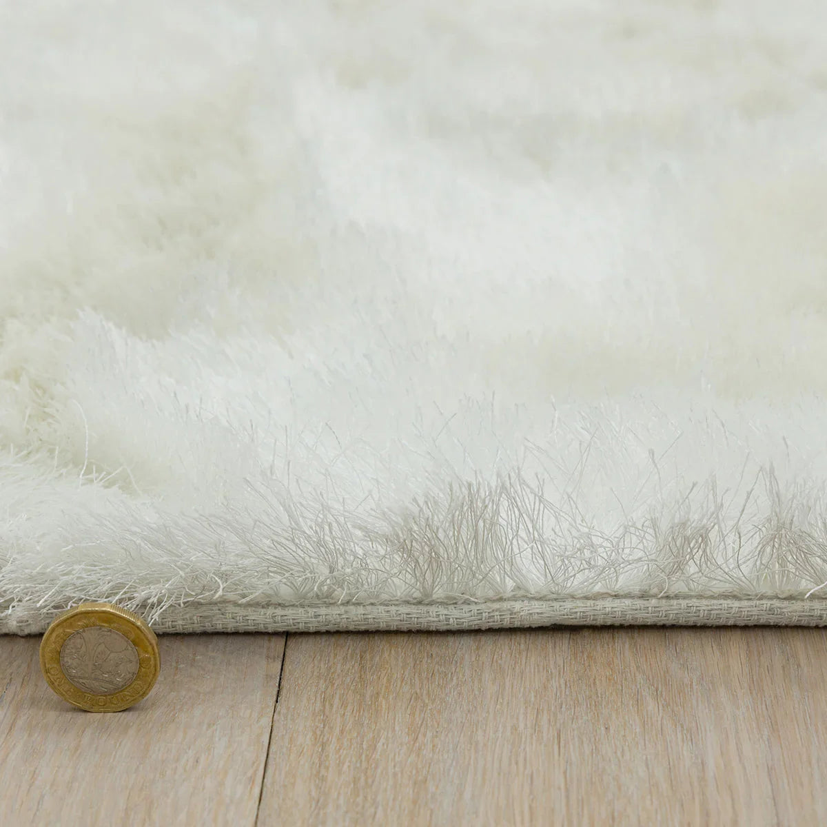 Asiatic Whisper Ivory Designer Rug featuring solid fluffy shag in ivory and cream on pale background, machine-made synthetic fibre