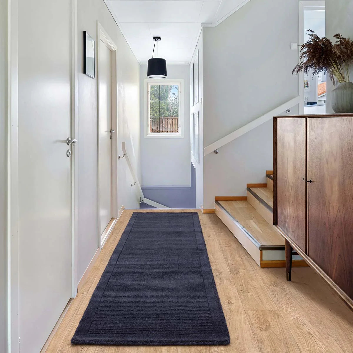Asiatic York Navy Designer Rug featuring solid ribbed runner in navy on light grey hallway floor, hand-tufted wool