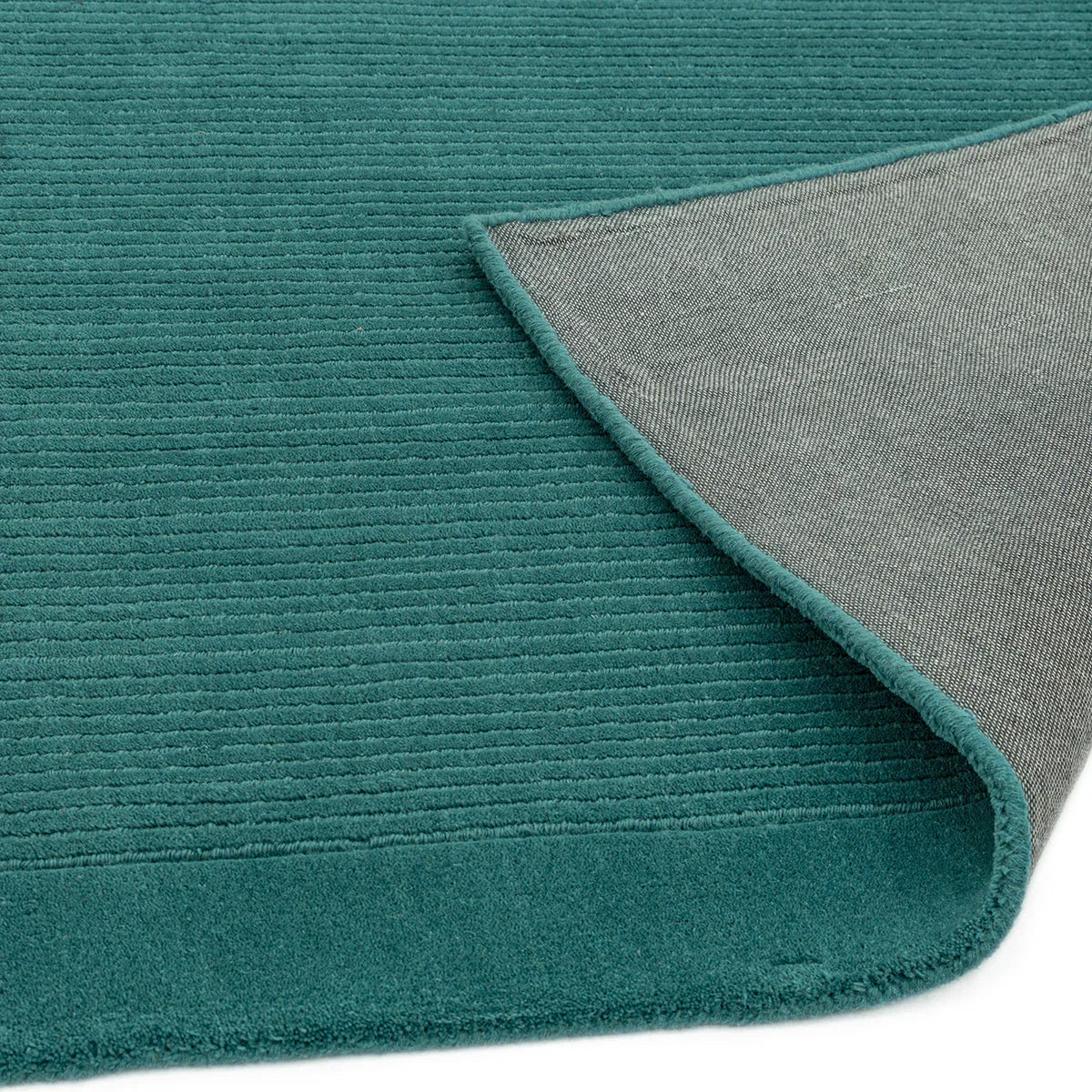 Asiatic York Teal Designer Rug featuring ribbed texture in teal with grey underside on white background, hand-tufted wool