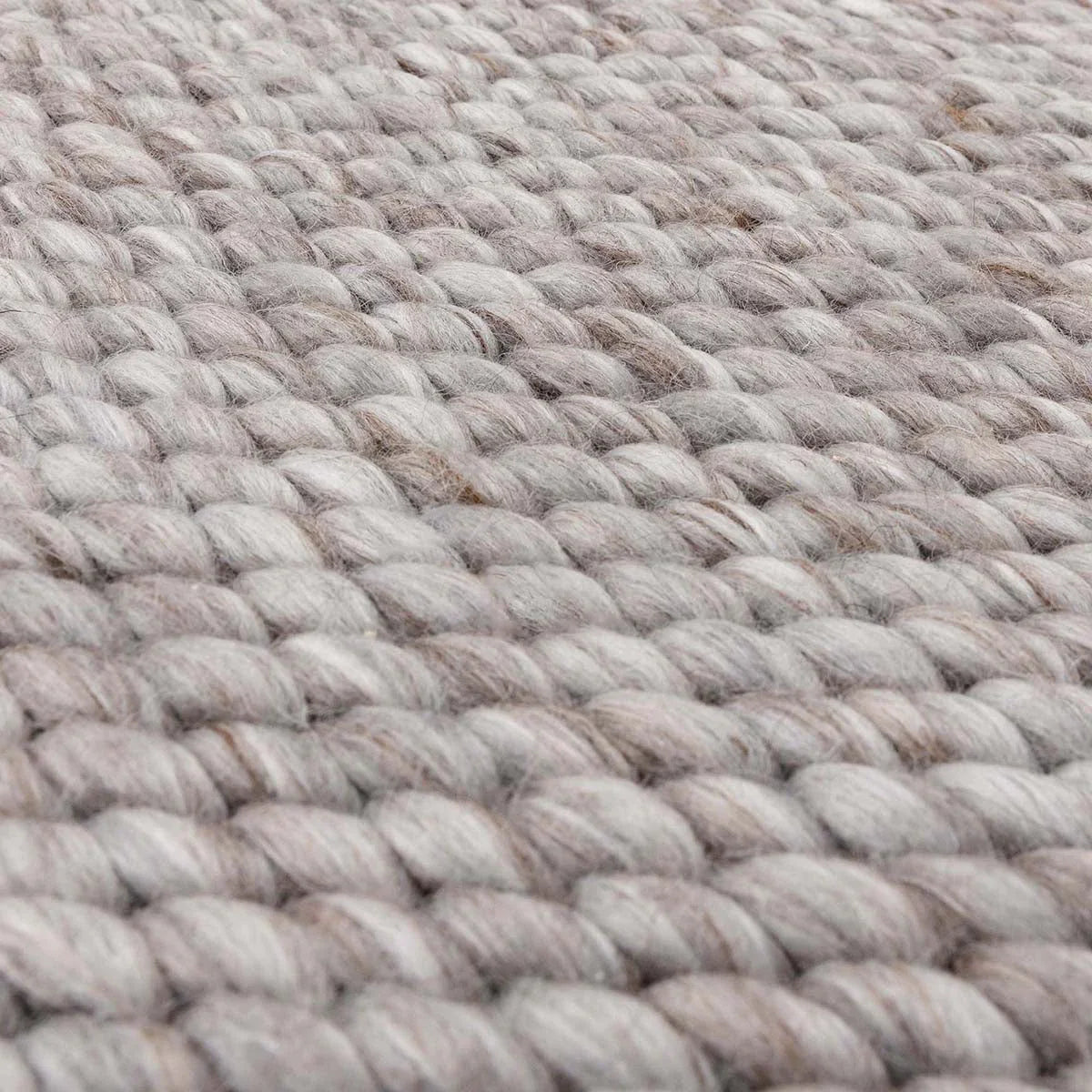 Asiatic Zander Charcoal rug featuring chunky textured weave in charcoal, gray and taupe on light gray background, hand-loomed wool