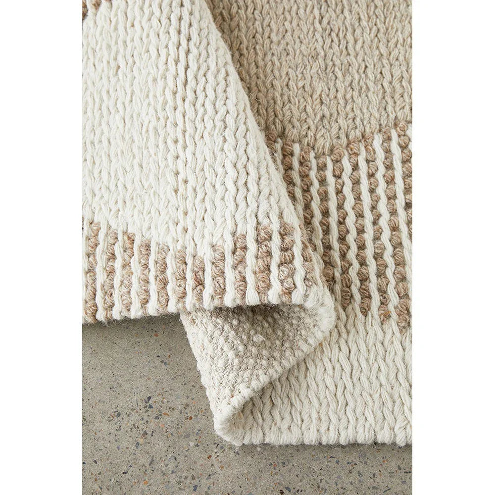 Avalon Shelly Natural Rug featuring chunky knit pattern in ivory, cream and taupe on natural cream background, hand-knitted wool