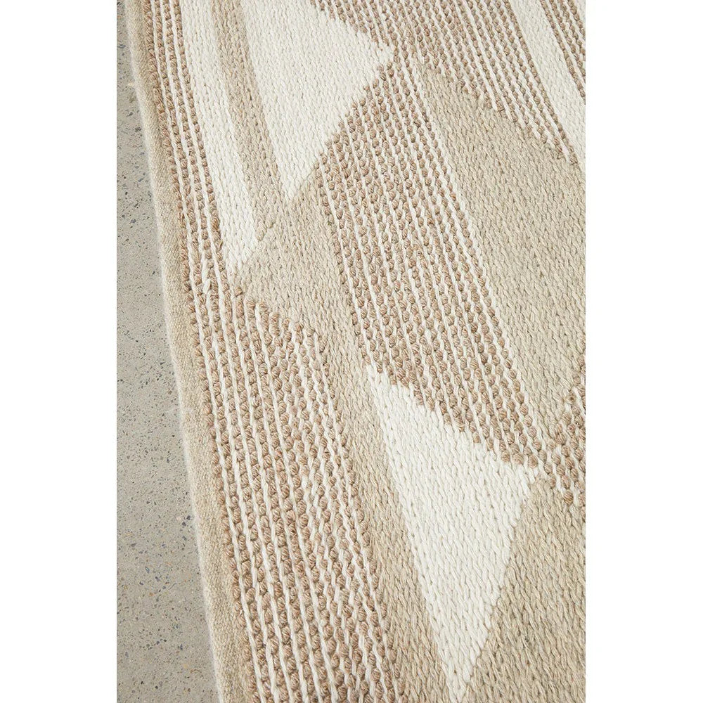 Avalon Taylor Natural Rug featuring geometric triangle pattern in cream, beige and taupe on light background, hand-tufted wool