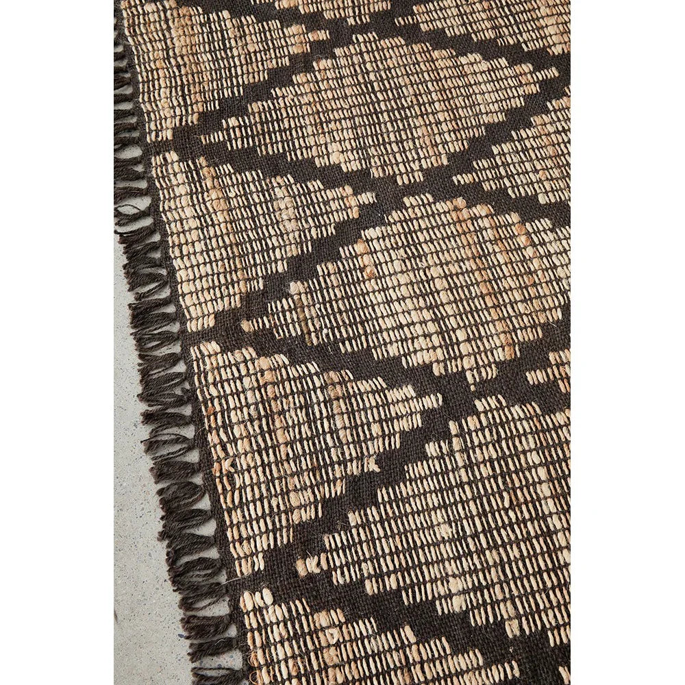 Bali Mocha Rug featuring geometric lattice pattern in mocha brown and tan on dark brown background, handwoven wool