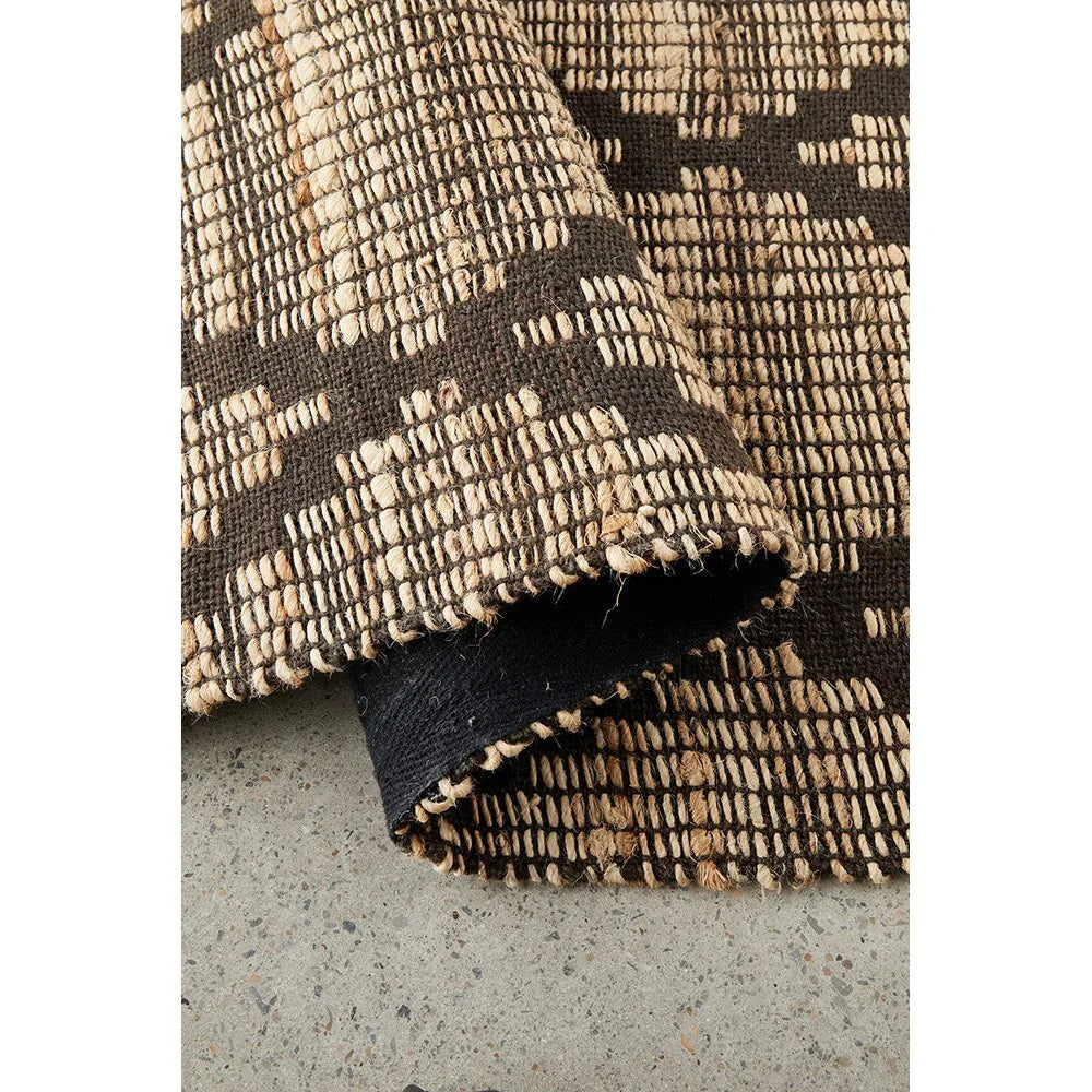 Bali Mocha Rug featuring geometric woven pattern in espresso brown and natural beige on dark base, hand-woven sustainable wool