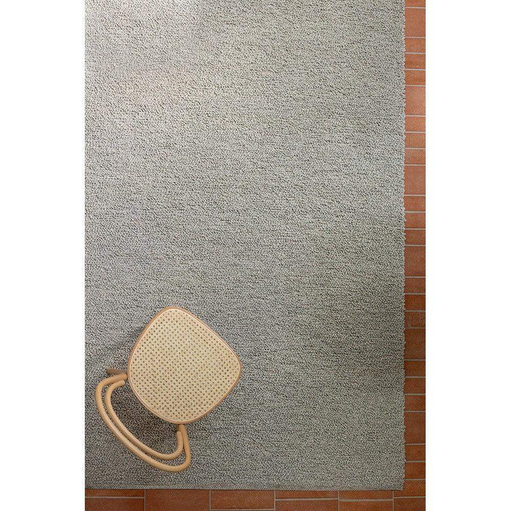 Brink & Campman Bond Ash Designer Rug featuring textured ash grey weave on brick-red floor, hand-tufted wool