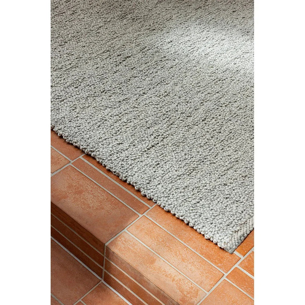 Brink & Campman Bond Ash Designer Rug featuring shaggy pile in ash grey on terracotta tile, hand-tufted wool blend