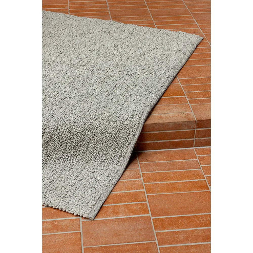 Brink & Campman Bond Ash Designer Rug featuring solid textured shag in ash grey on terracotta background, machine-made wool