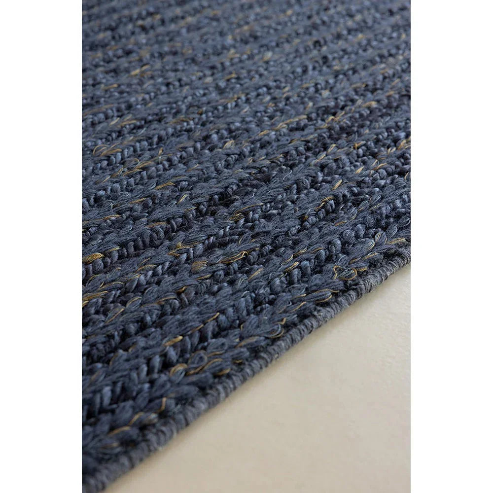 Brink & Campman Craft Plait Denim Rug featuring braided plait pattern in denim blue, navy and beige on light background, hand-woven wool