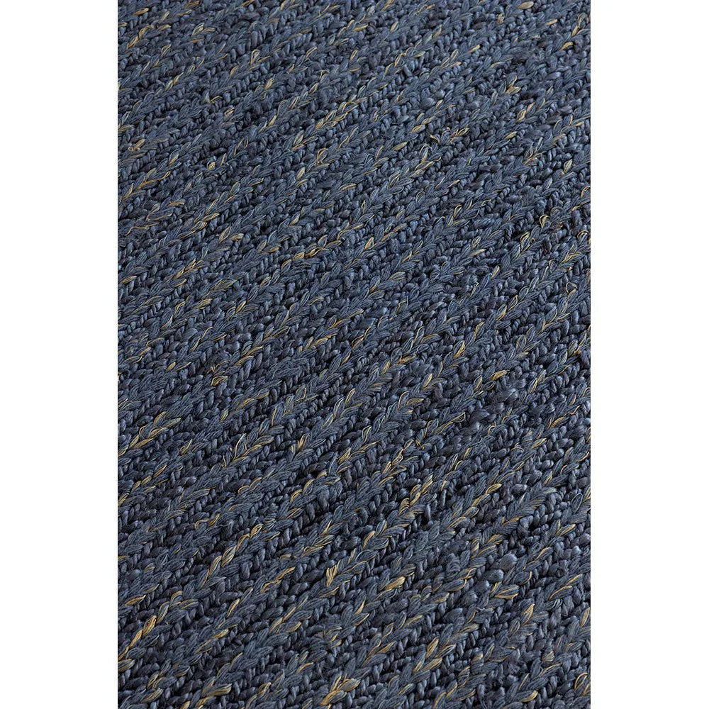 Brink & Campman Craft Plait Denim Rug featuring braided navy weave with subtle sand accents on denim background, handwoven wool